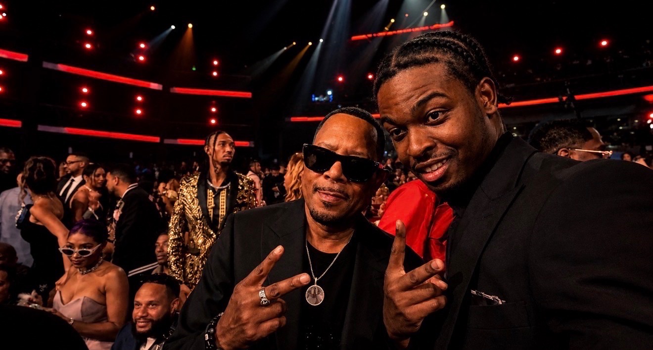 Two guests posing inside the BET Awards 2026 room during entertainment media coverage