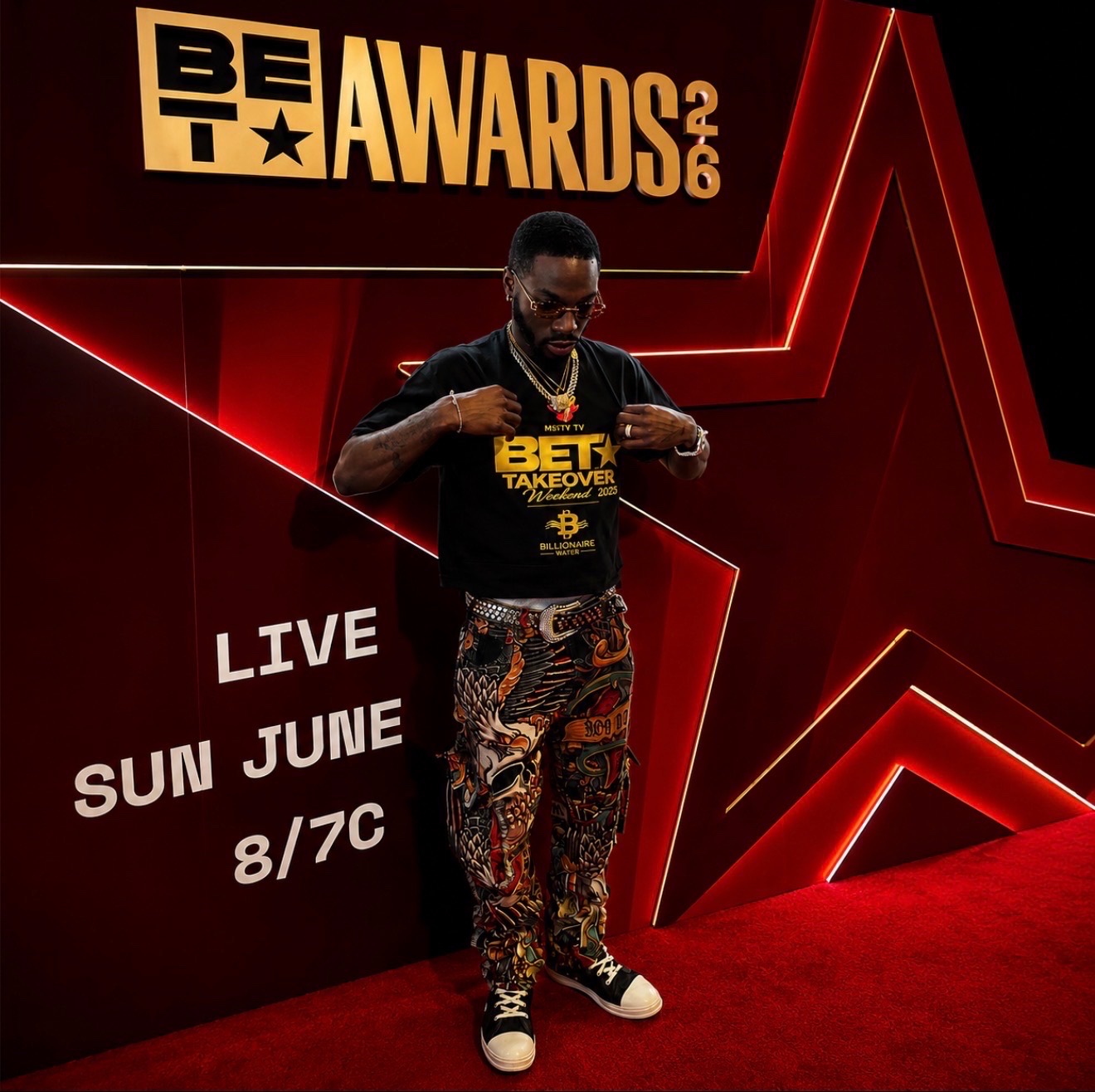 Guest solo portrait at the BET Awards 2026 red backdrop during red carpet coverage