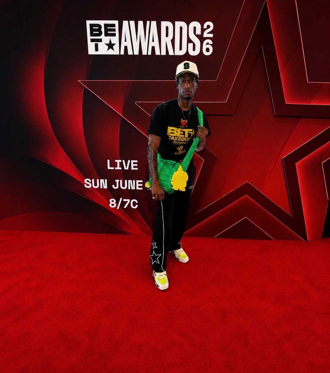 Guest posing solo at BET Awards 2026 backdrop during The Misty TV Firm red carpet recap