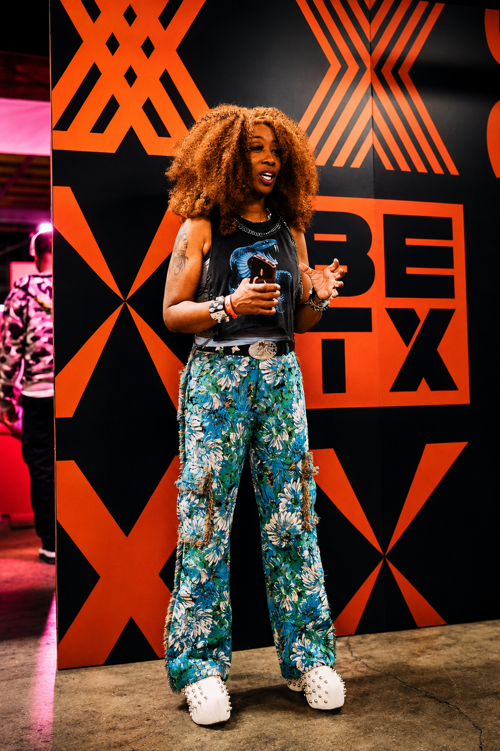 Guest standing in front of BETX branding during BET Experience 2026 entertainment coverage