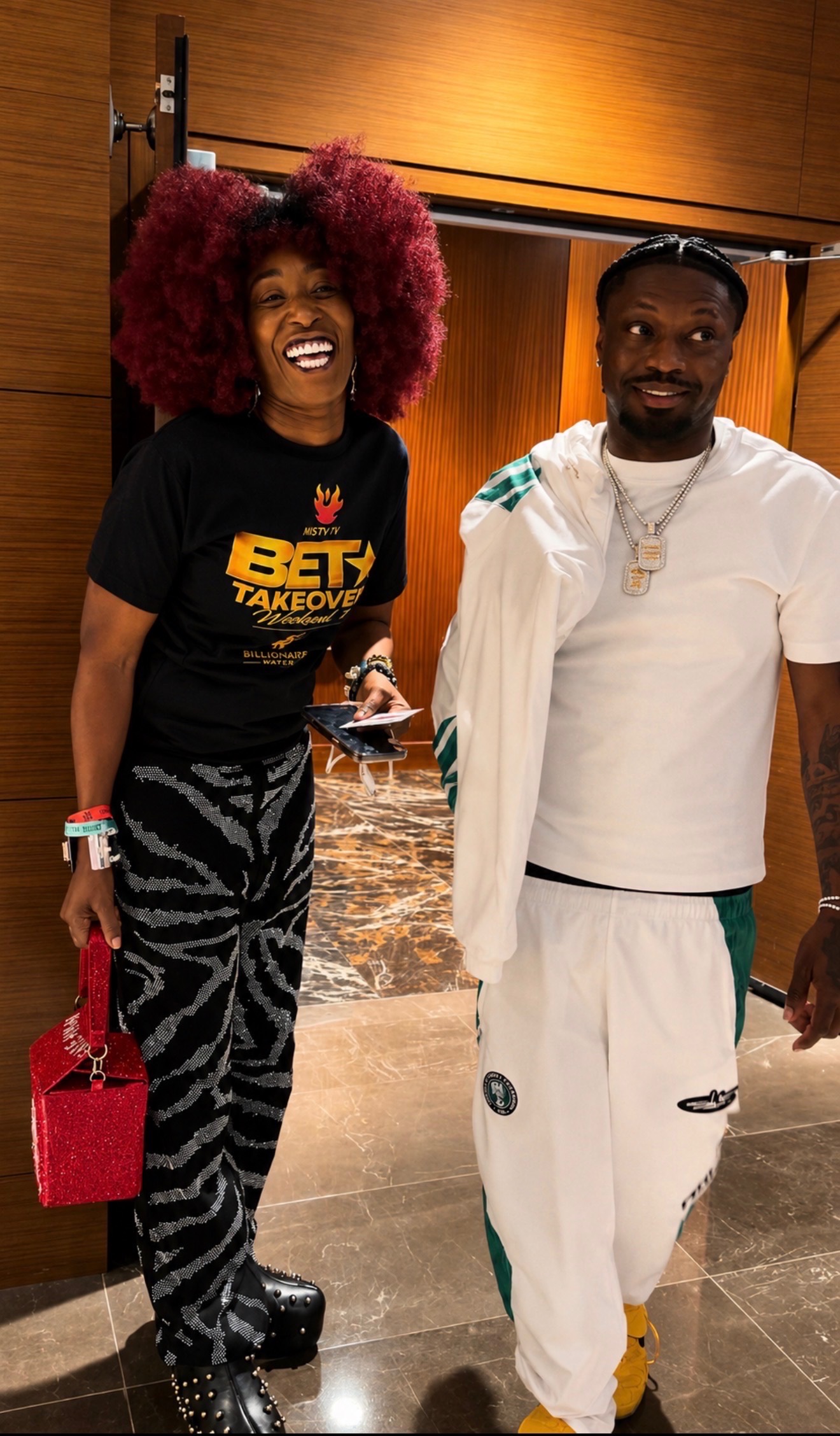 Two guests smiling in a warm lobby moment during BET Awards Weekend 2026