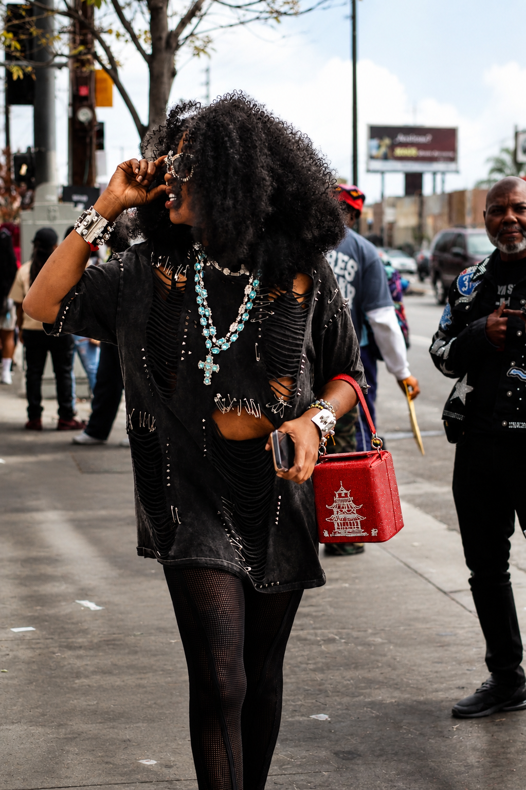 Street style guest with red bag outside a BET Weekend 2026 entertainment event