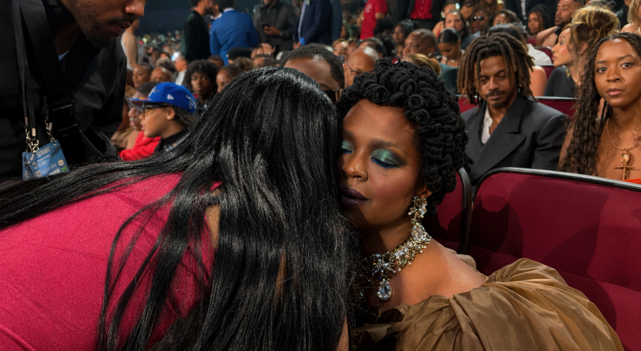 Misty Blanco greeting a seated guest inside the BET Awards room during red carpet and audience coverage