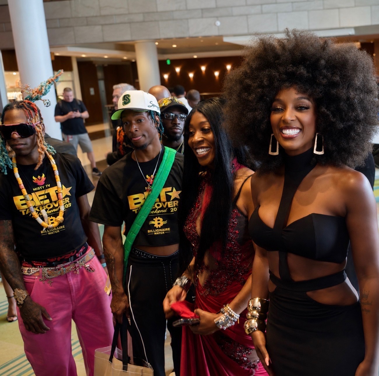 Misty Blanco smiling with The Misty TV Firm team and guests in a venue lobby during BET Weekend 2026