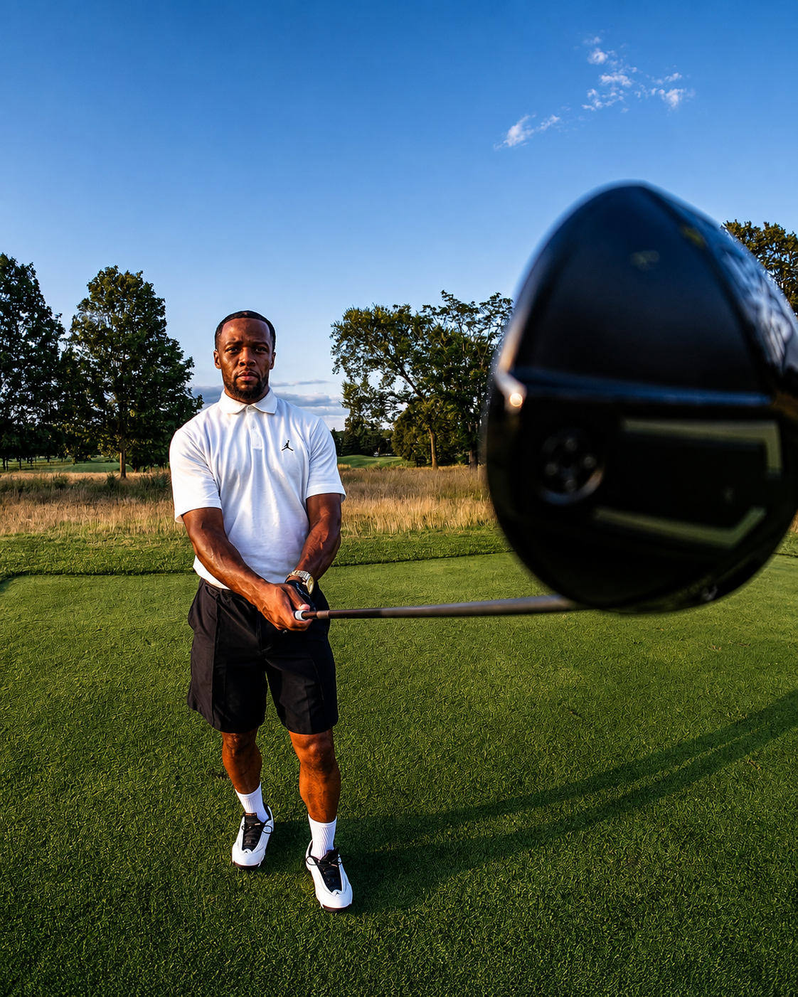 Tim Mercer holding a golf driver on the course
